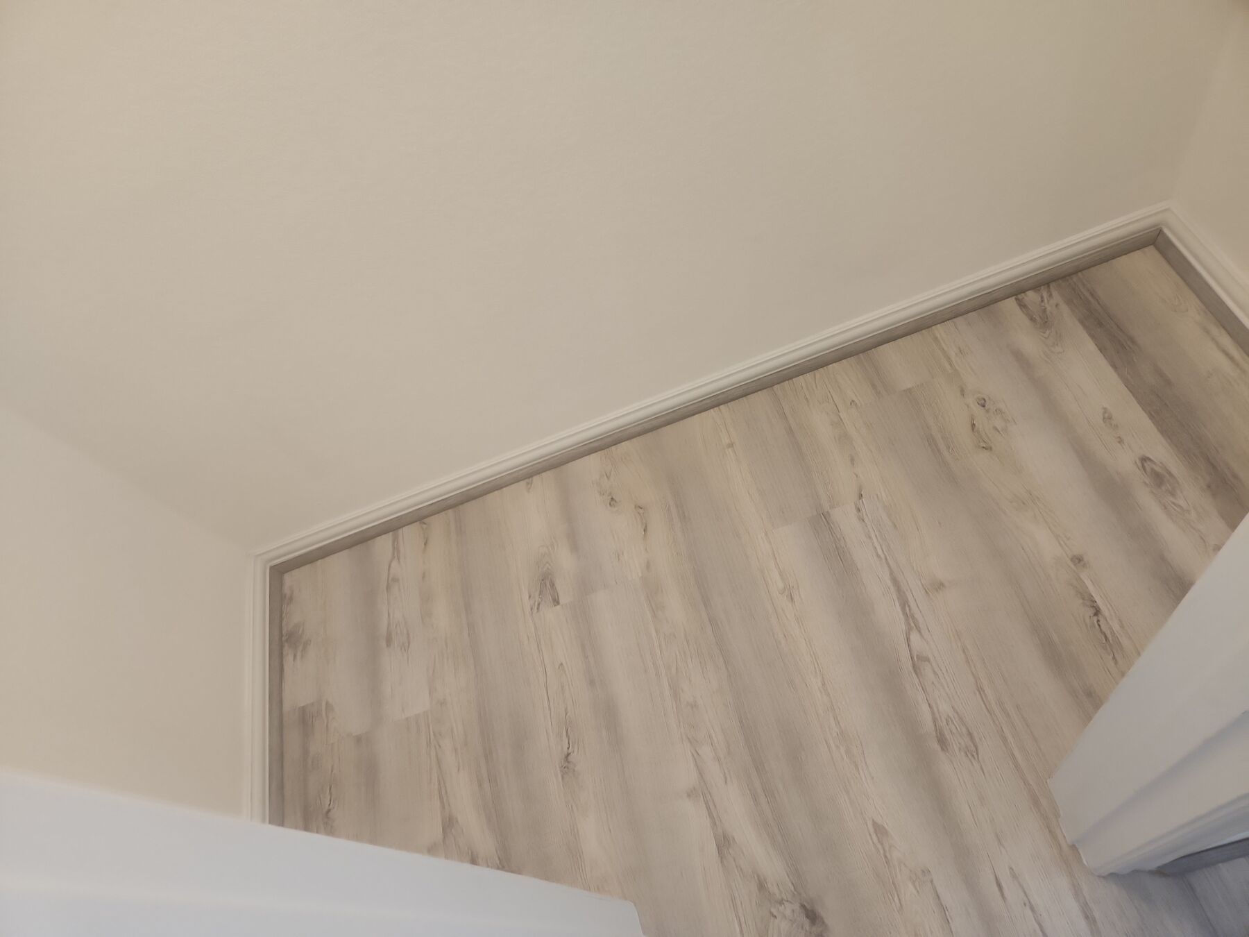 Wood-look floors, trim, and painting completed by HRH Repairs