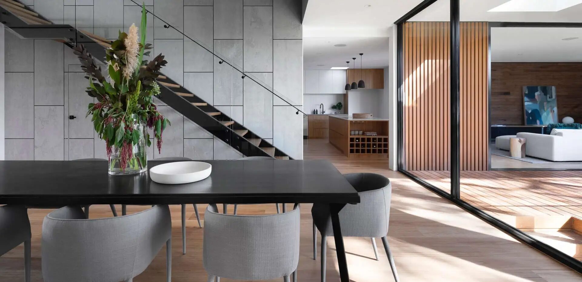 Contemporary open-plan home featured by HRH Repairs, with wood floors and custom kitchen finishes